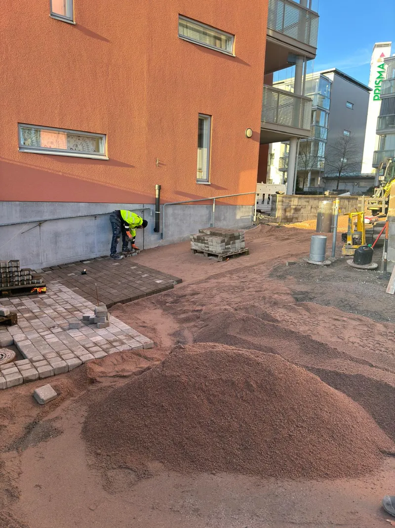 Massanvaihto käynnissä rakennuksen vierellä